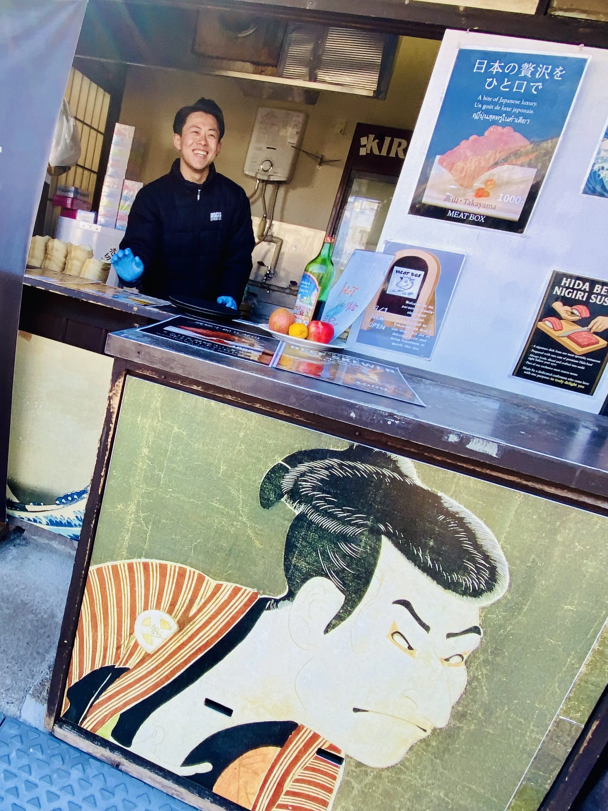 A street food vendor offers local food specialities in Takayama, Japan