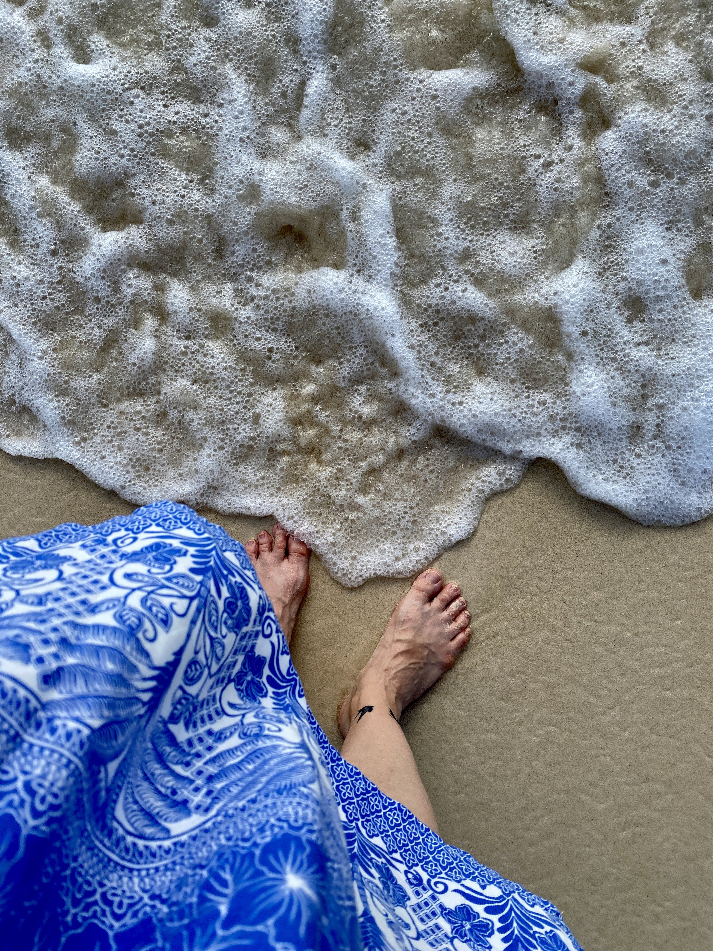 toes in Cayman clear water