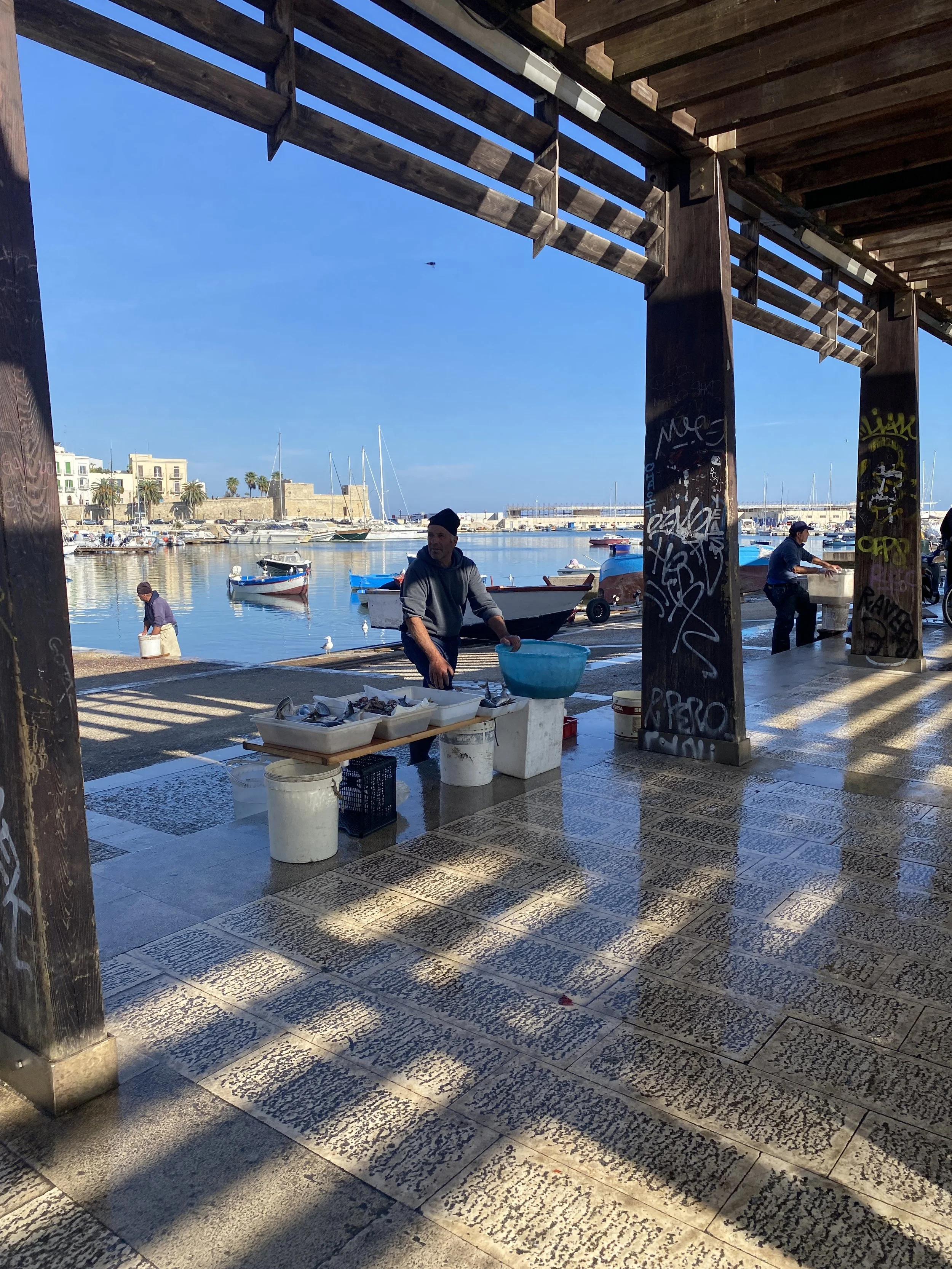 Fishermen selling their wares in Bari's fish market in Puglia, Italy