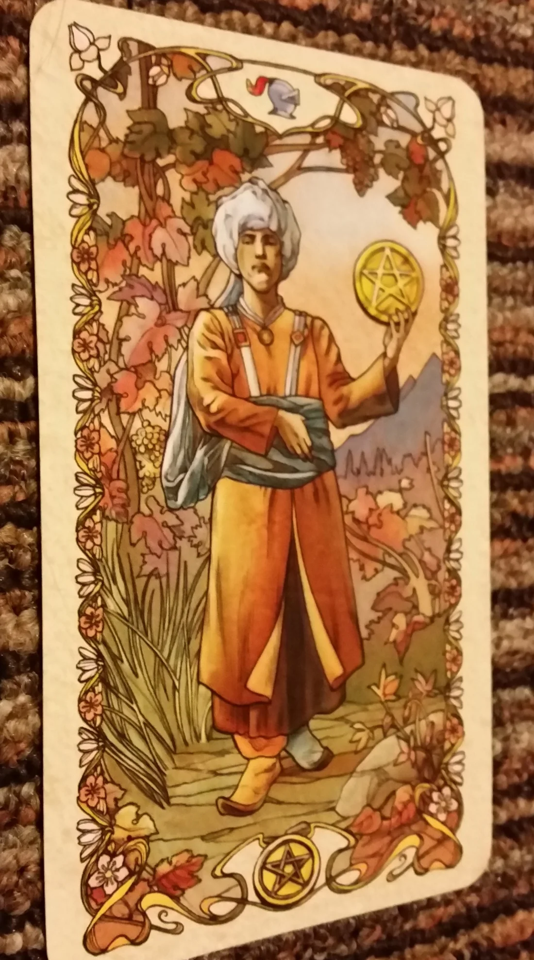 The Knave of Pentacles is wearing an orange shoe and a blue shoe: Broncos colors.
