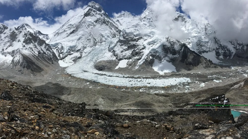 Everest's black pyramid towering 2 miles above basecamp