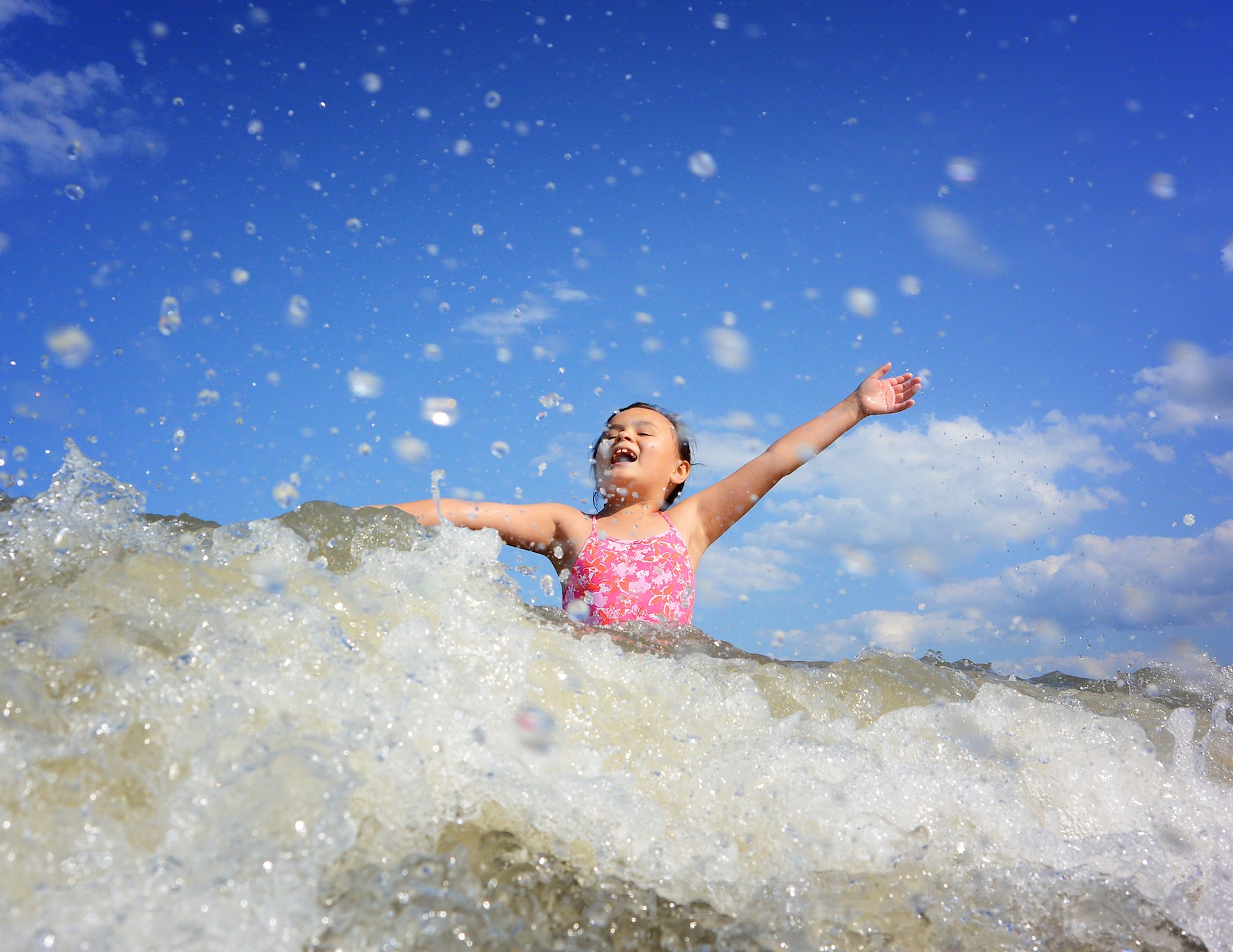 Nikon AW1 at Rehoboth Beach, DE, as a wave came crashing down, with a perfect expression, and water droplets flying everywhere.