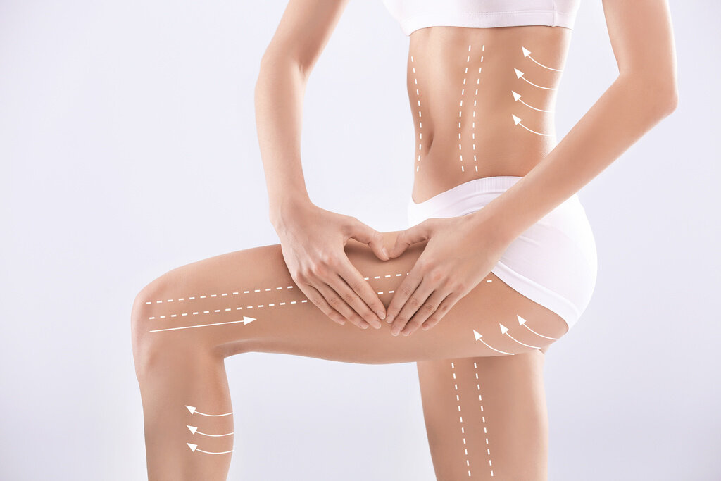 Young woman with beautiful slim body on light background