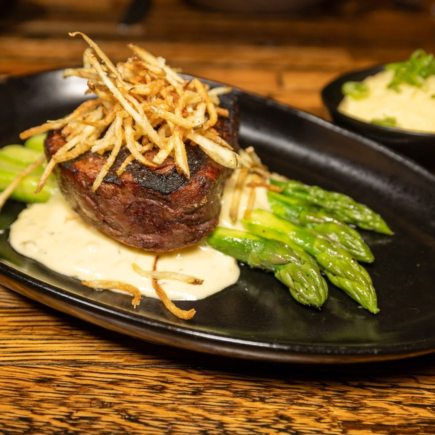 A classic: 8oz filet mignon, saut&eacute;ed asparagus, roasted garlic yukon mash, b&eacute;arnaise sauce. #winteri̇scoming #parkcityrestaurants