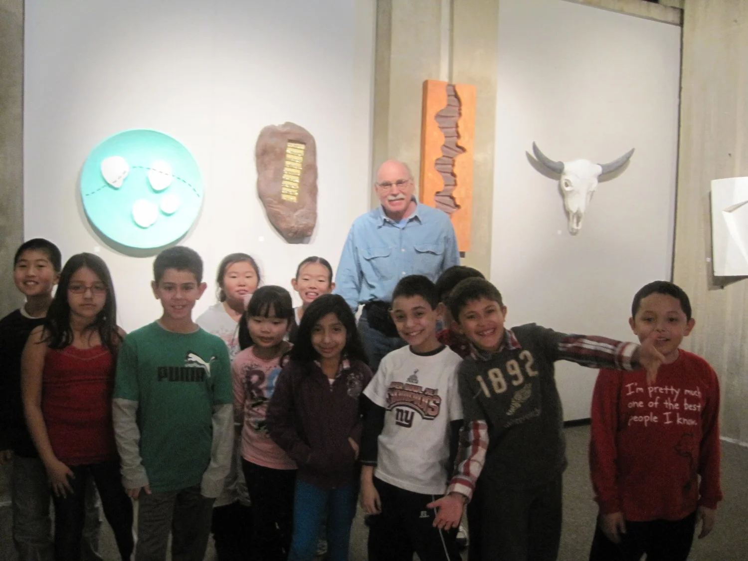 Art program at local Library. Elementary students tour artwork with the artist.