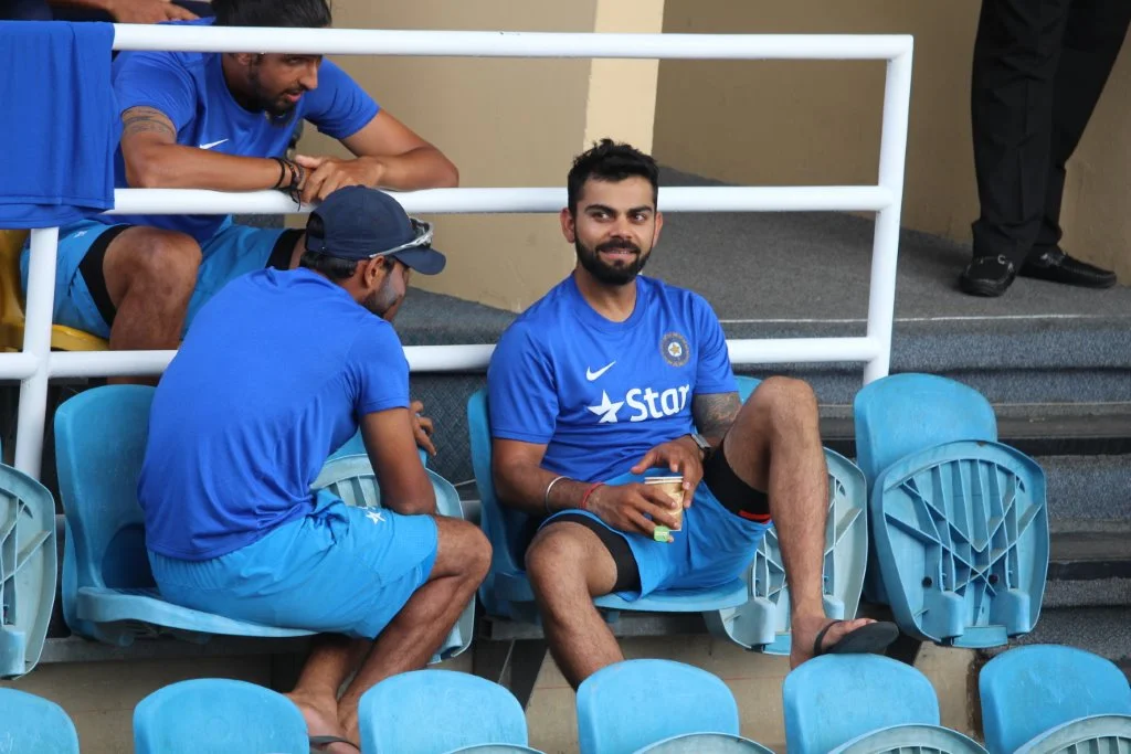 India team captain Virat Kohli (bottom right) relaxes with teammates outside the players’ dressing room during the fourth “test” match between India and the West Indies at the Queen’s Park Oval in Trinidad in August 2016. They were waiting for the umpires to complete their inspection of the water-logged field. The game eventually was called off because of the adverse playing conditions. (Photo by Ewart Rouse. All rights reserved)