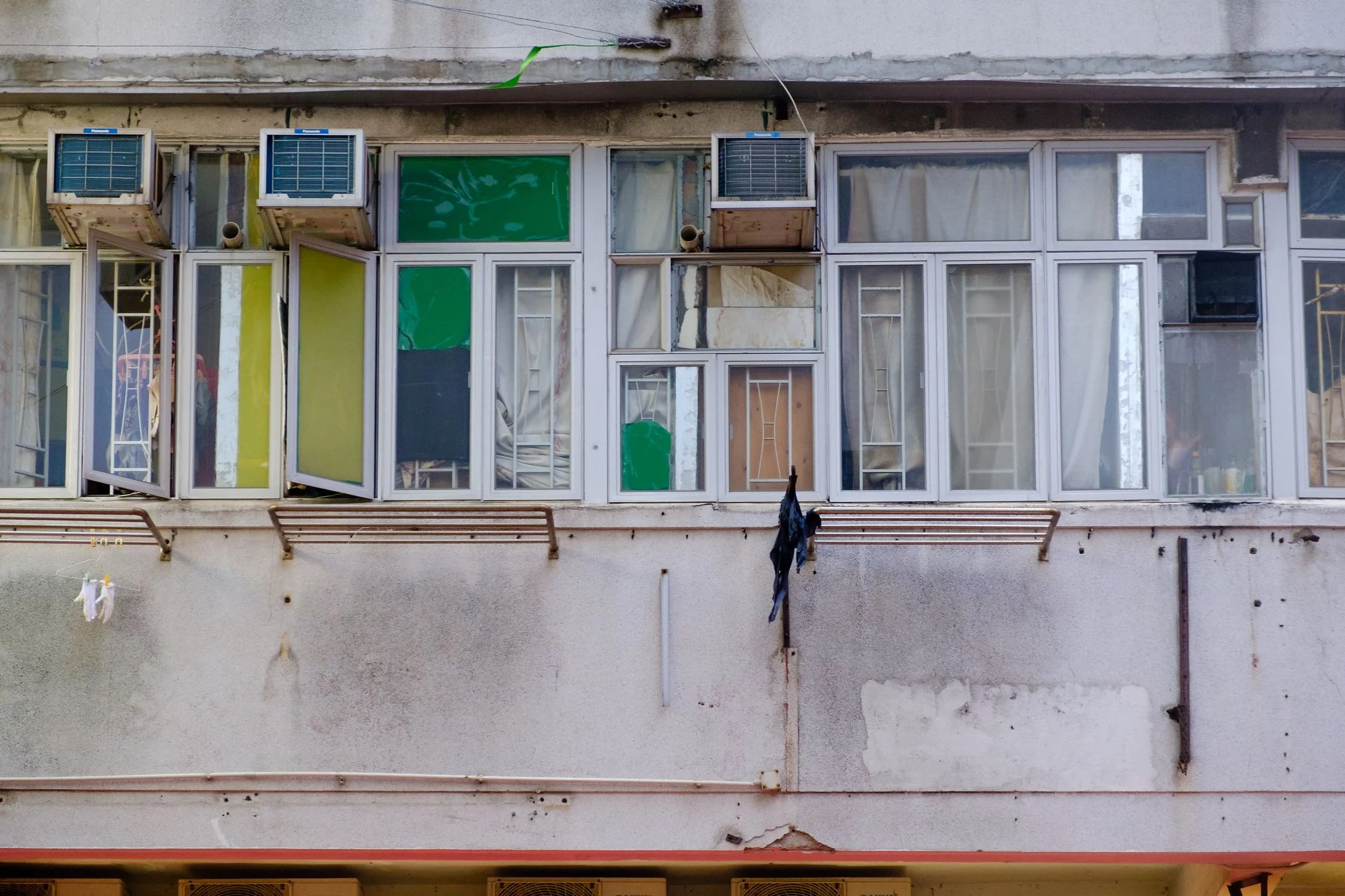 The price of rents in Hongkong are enormous, that’s why people subdivide their rooms in smaller units. Officially it is not allowed, however you can notice it when looking on the windows from outside. Every window has a different decoration or even aircon.