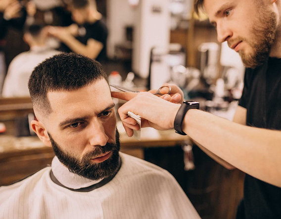 Barber carefully shaping a client’s beard with clippers for a polished look at a barbershop in Wrigleyville.