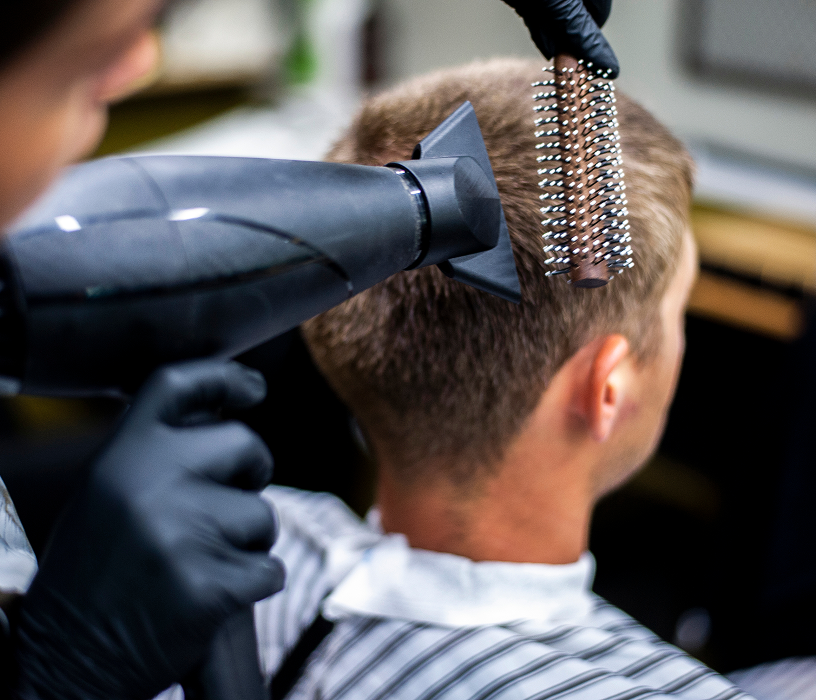 Man with full curly textured perm men result showing voluminous defined curls on short to medium hair