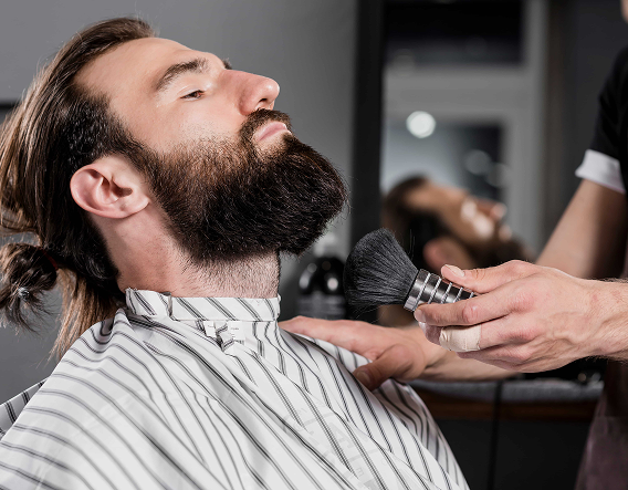 Side profile of a precise skin fade created with clippers during a professional men's haircut.
