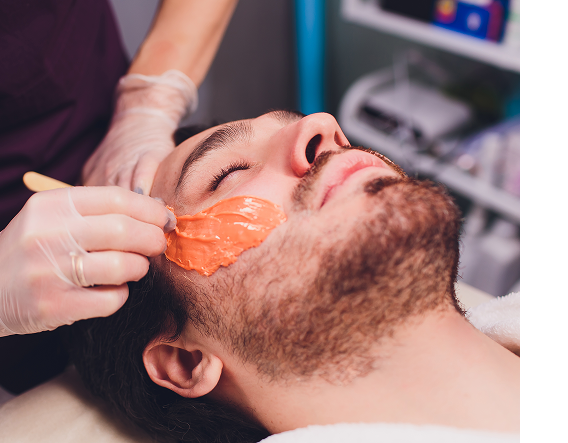 Smiling man during in-clinic treatment illustrating recommended chemical peel frequency for consistent, structured results.