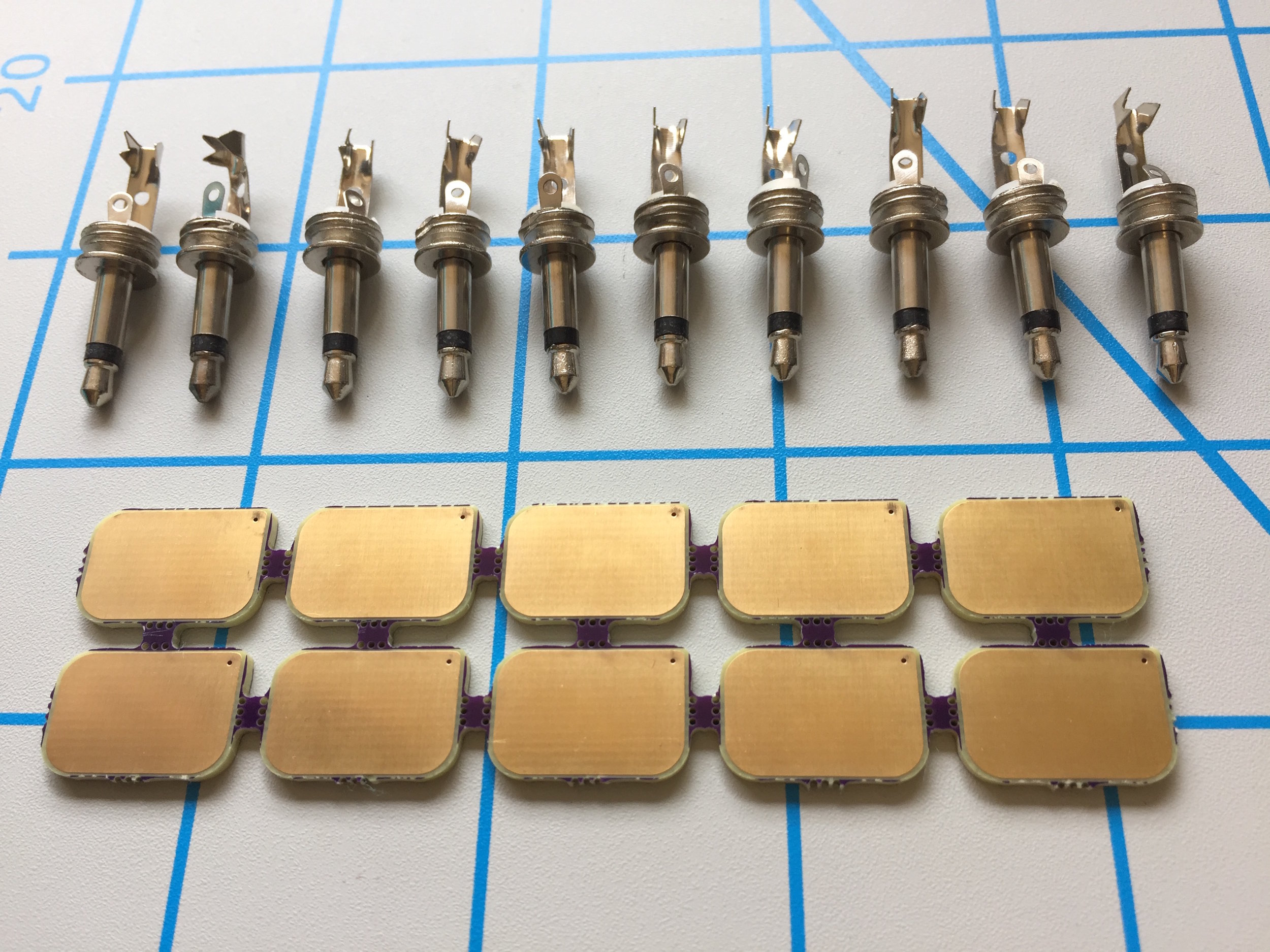1. Unpack the kit double checking that you have 10x 3.5mm mono plugs and 10x AllFlesh pcbs. Using clippers (or your hands) break apart all 10 PCBs at the perforation marks and remove any remaining small tabs. ( Note: I have not done that in my photo examples but this will help you in later steps to not damage your solder joints). Unscrew the mono plugs from their black plastic housings. You will need on hand safety glasses, a soldering iron, solder, clippers, and a file. ** Though I don’t love leaded solder it can be very beneficial for learning soldering and in this instance especially so because the melting point is low. Leaving the iron in contact with the solder lugs for too long or making the iron too hot can ruin the plug internals **