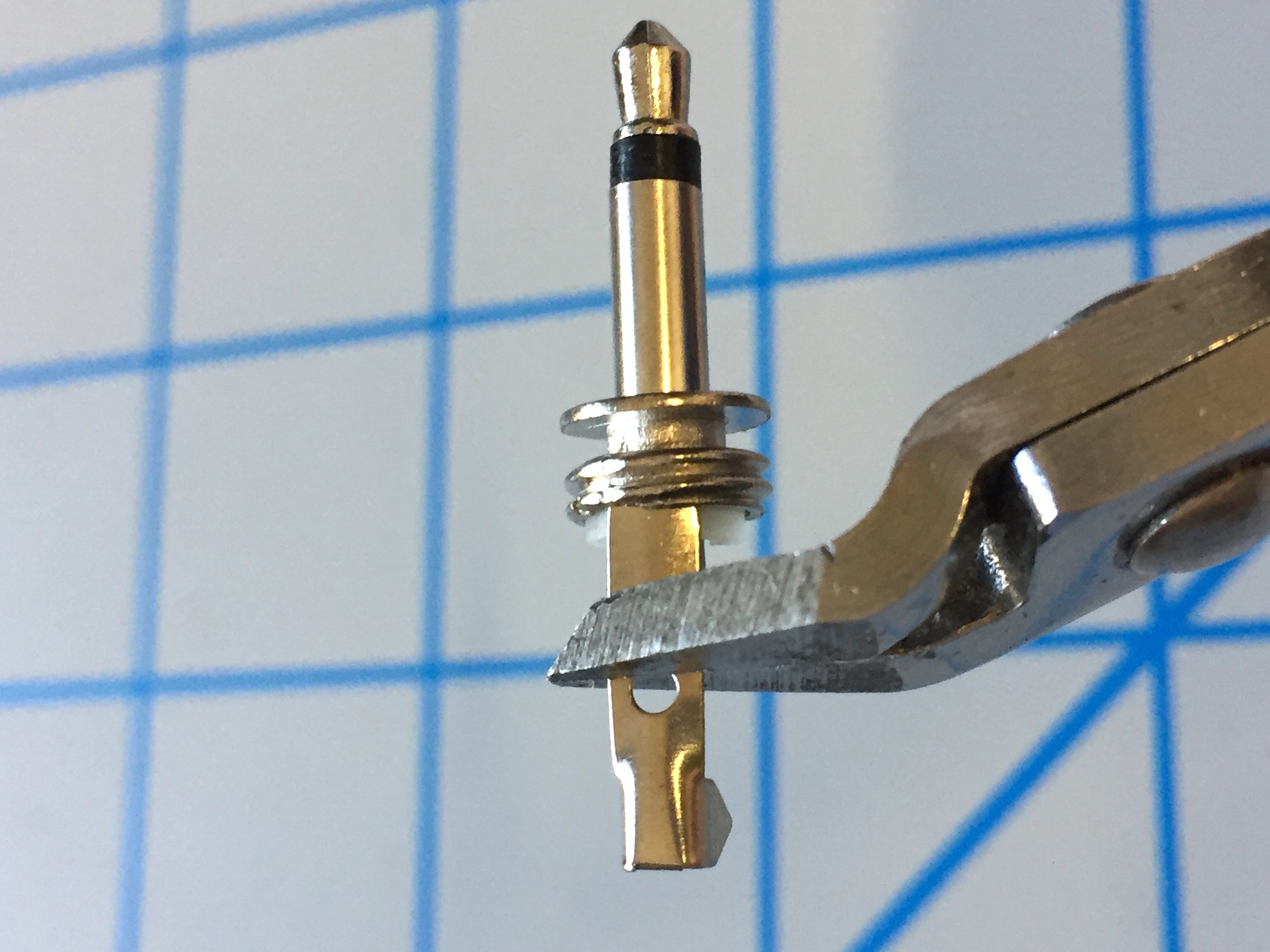 2. Using your clippers, trim only the ground connection lug (the larger one) of the plugs just below the circular cutout.