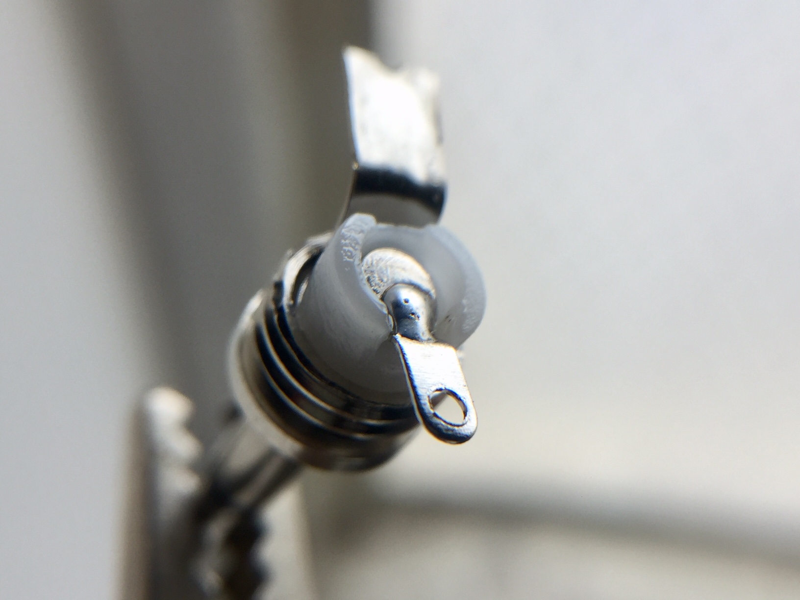 Note: Please consider using some thin solder to span/connect the center pin with the small lug as seen in this photo. That will give your plug extra strength and make it less vulnerable to damage from excess heat during the final soldering process.