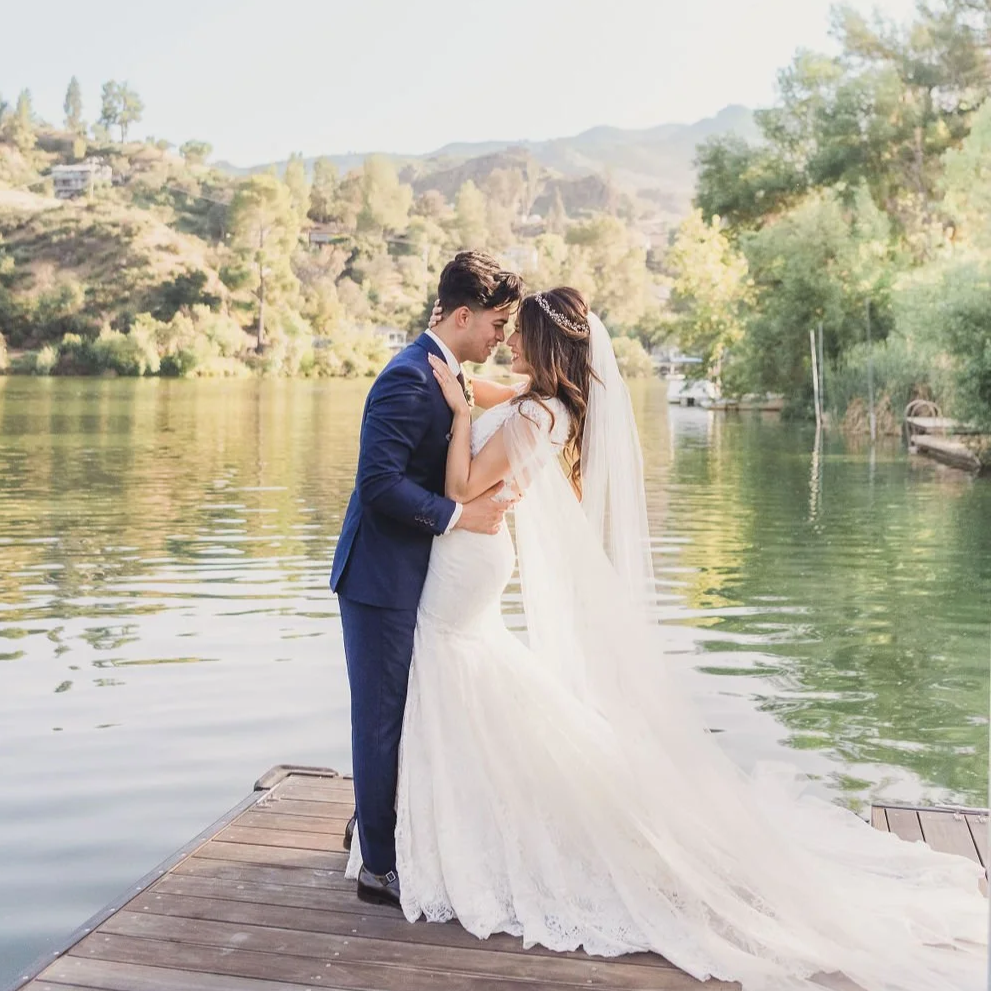 A bride and groom kiss on a private dock at their April wedding at The Lodge at Malibou Lake near Calabasas CA.