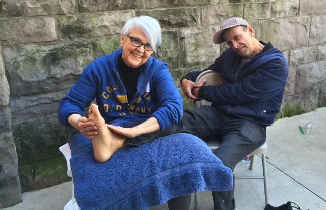 Care Through Touch practitioner offering compassionate foot massage to support comfort, relaxation, and human connection.