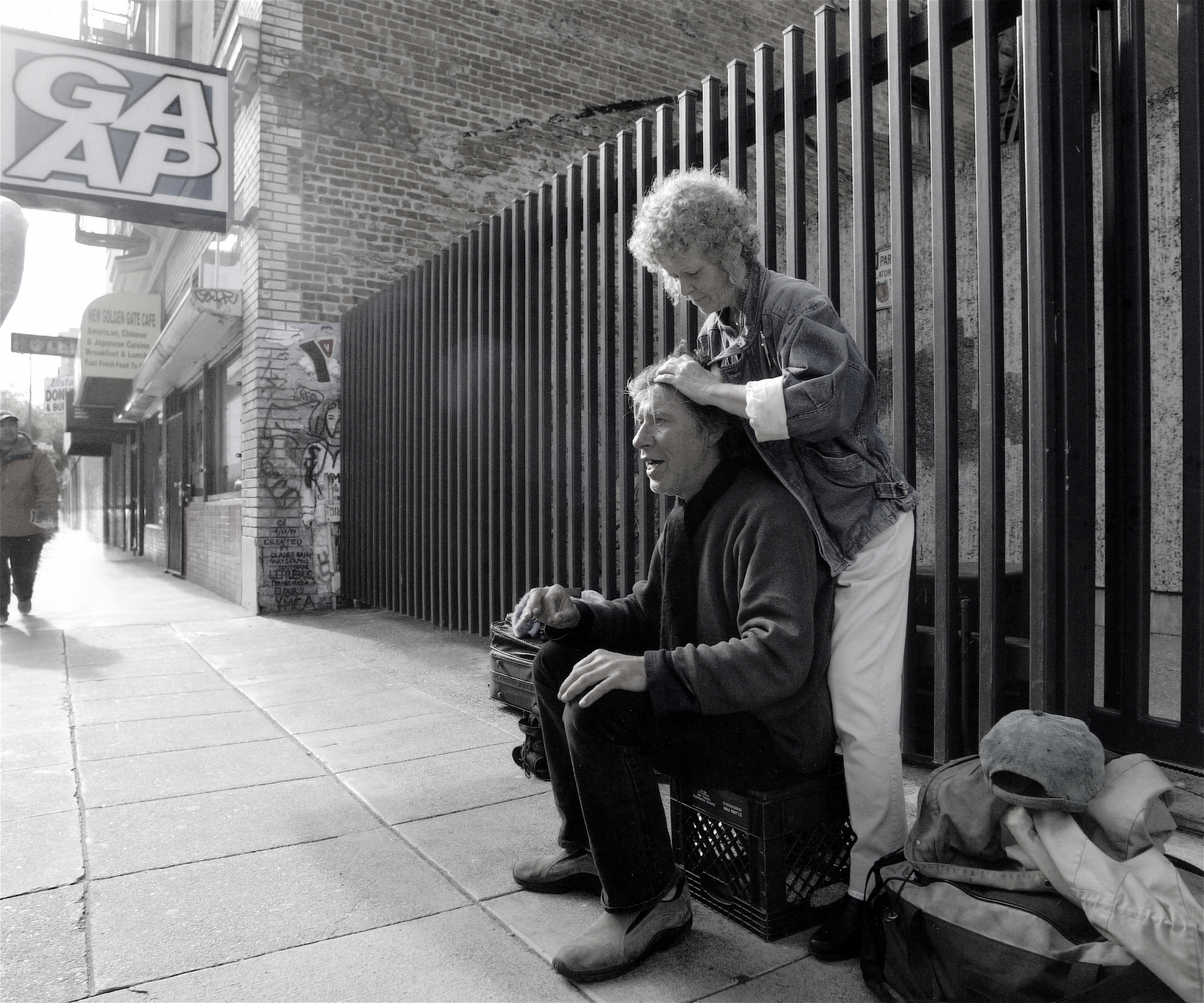 Founder and massage therapist providing free chair massage to a community member in San Francisco.