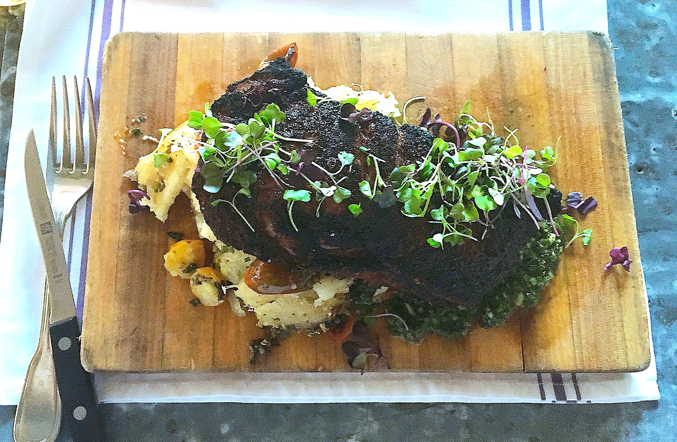 16 oz. espresso rubbed dry-aged rib eye // oven roasted yucca, baby heirloom tomatoes, house chimichurri 