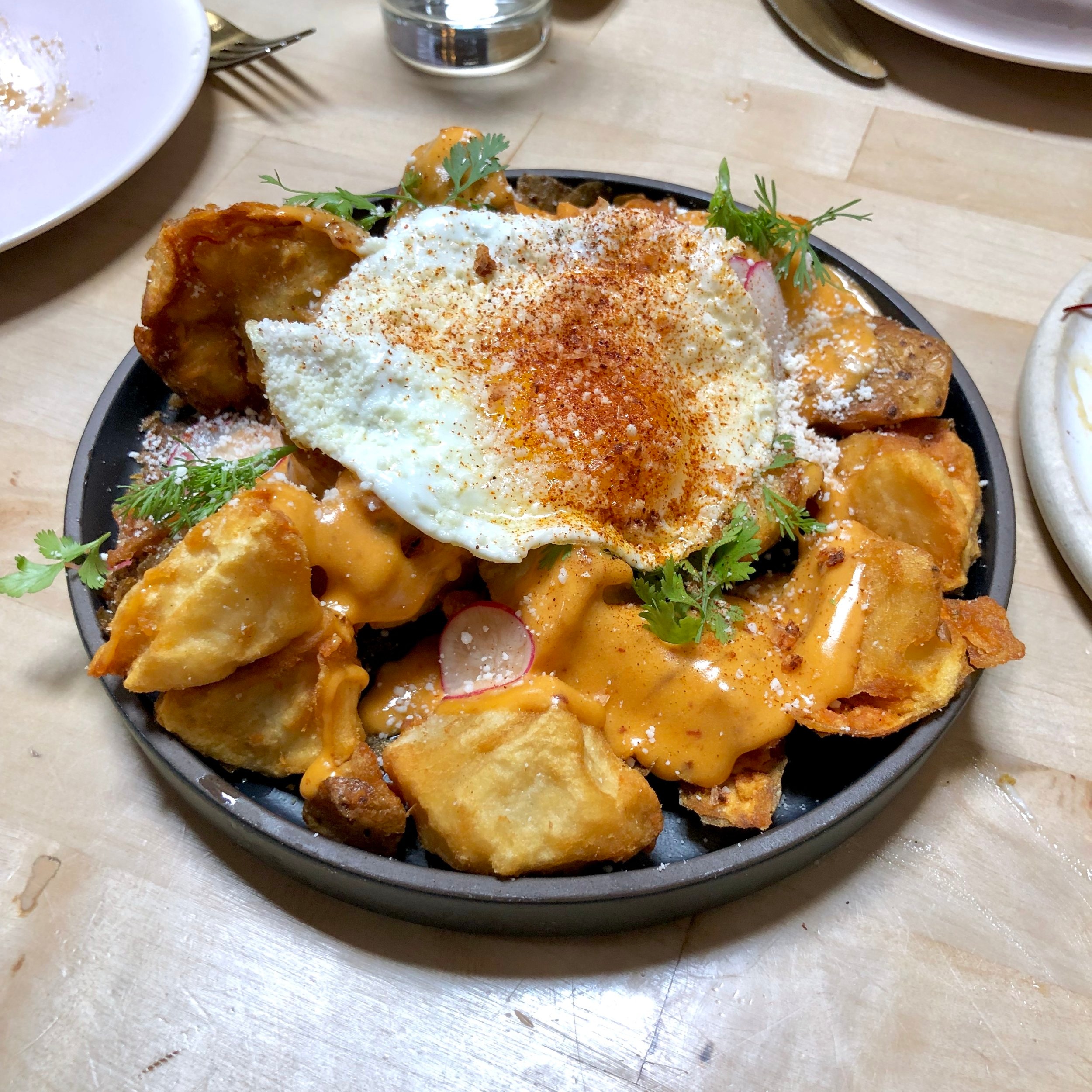  loaded crispy smashed potatoes // sunny egg, chipotle queso, salsa taquero 