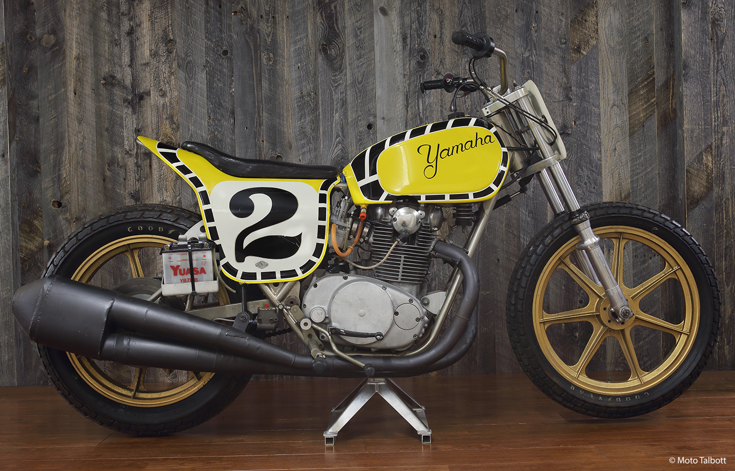 Kenny Roberts was Grand National champion in ’73 and ’74, when he scored 2,286 points, collecting points in all 23 races. The dirt track bike you see here has custom side cases, flatside carburetors, a nickel-plated monoshock frame, a striking side-mounted battery, and a vintage set of Goodyear tires.