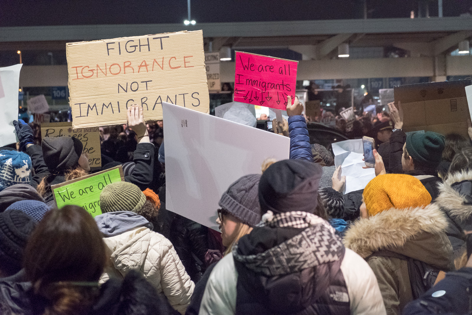 Protesters Saturday night at John F. Kennedy Airport in New York City welcome immigrants following the Executive Order by the Trump Administration. Photo courtesy of Luminary Traveler of the Flickr Creative Commons. 