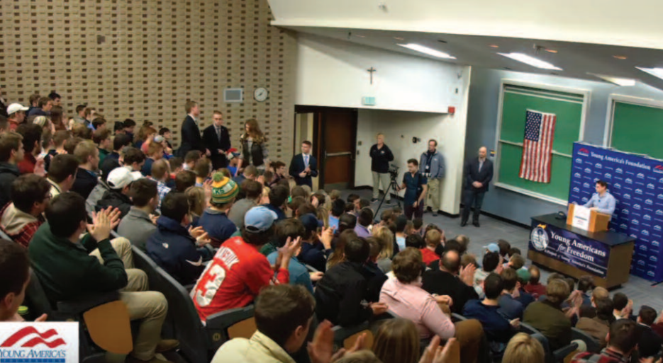 Ben Shapiro speaks to students in a packed lecture hall at Marquette University . 
