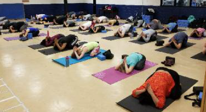 Saint Peter's University community members in Balasana (Child's Pose)