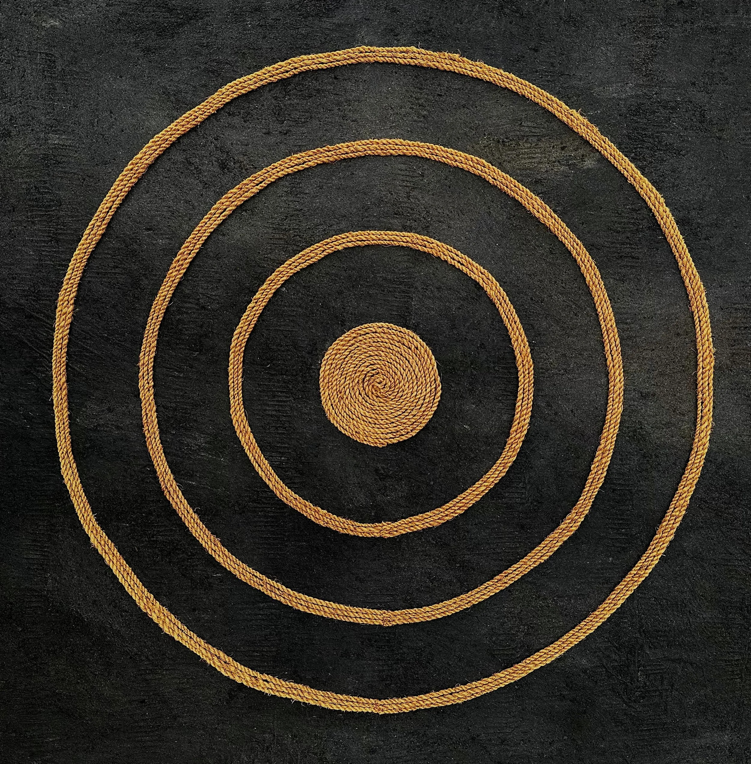 Eia Ke Kumu (There Is The Source). Wildfire charcoal, micaceous sand, and ʻolonā cordage on kapa. 23 inches x 23 inches. 2025.