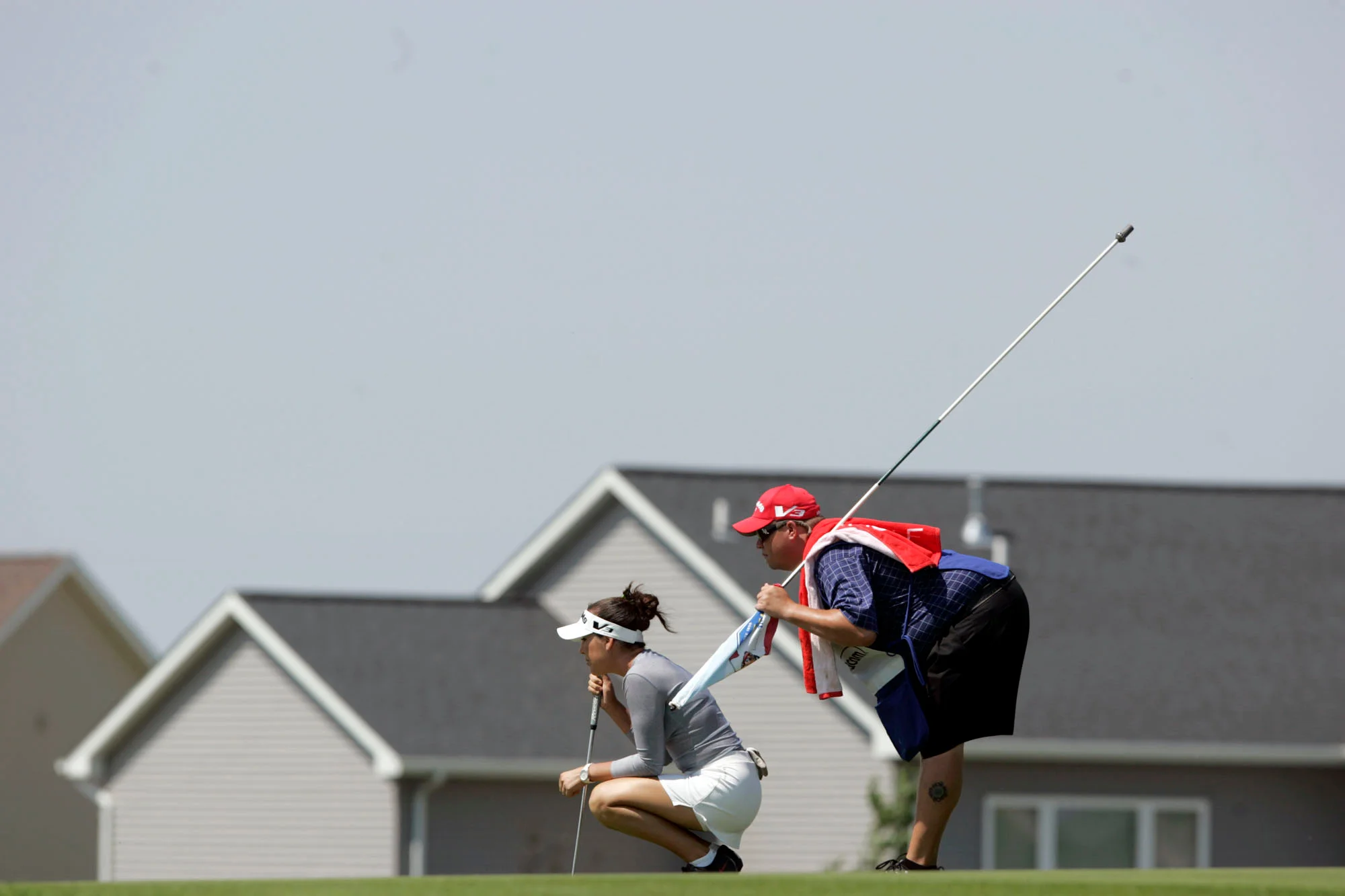 Carling Coffing and her caddy line up her putt on the seventh hole green during the final round of the Ladies Titan Tire Challenge at Hunters Ridge Golf Course in Marion.