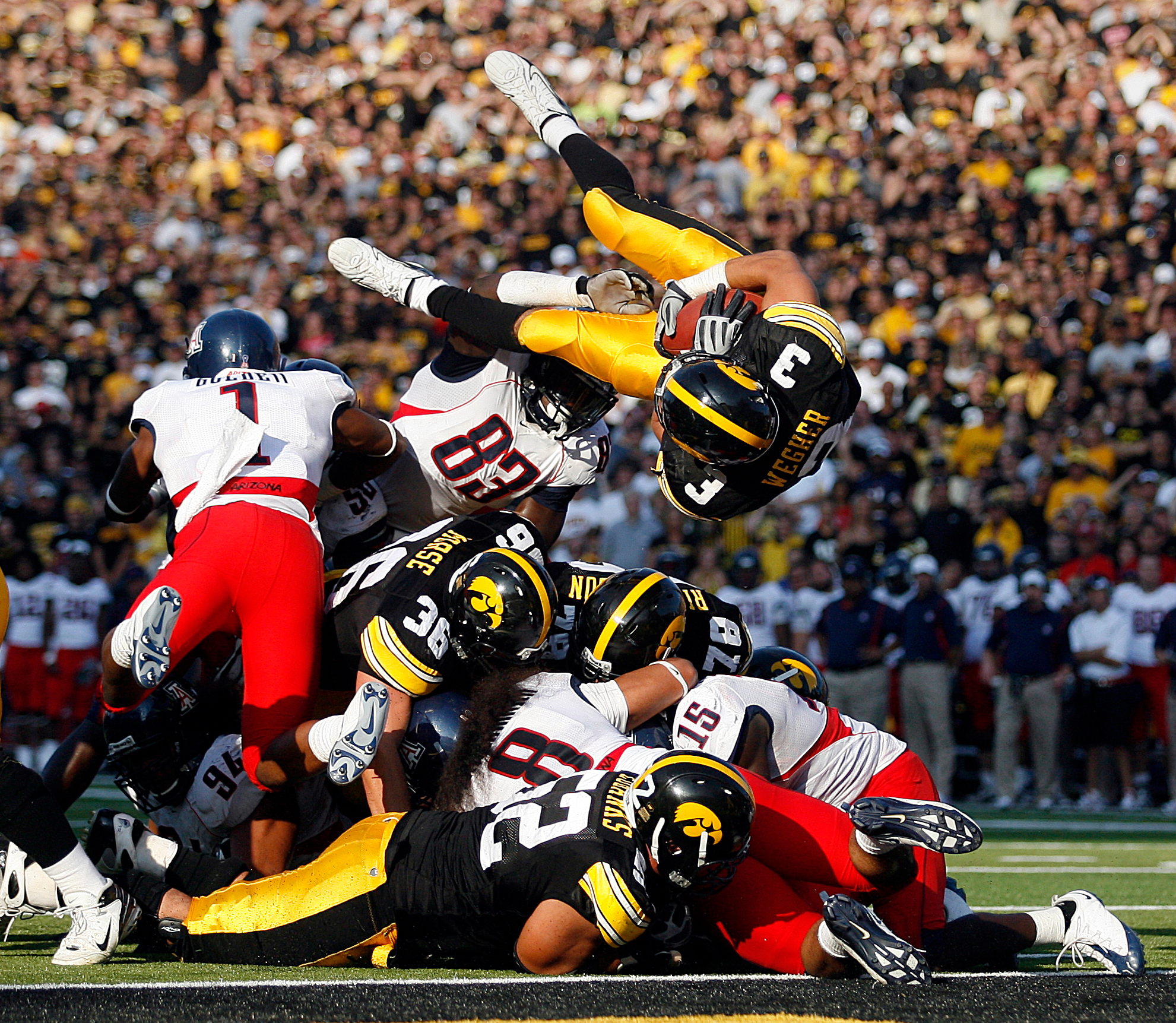 Iowa's Brandon Wegher leaps into the end zone during the Hawkeyes' game against Arizona at Kinnick Stadium.