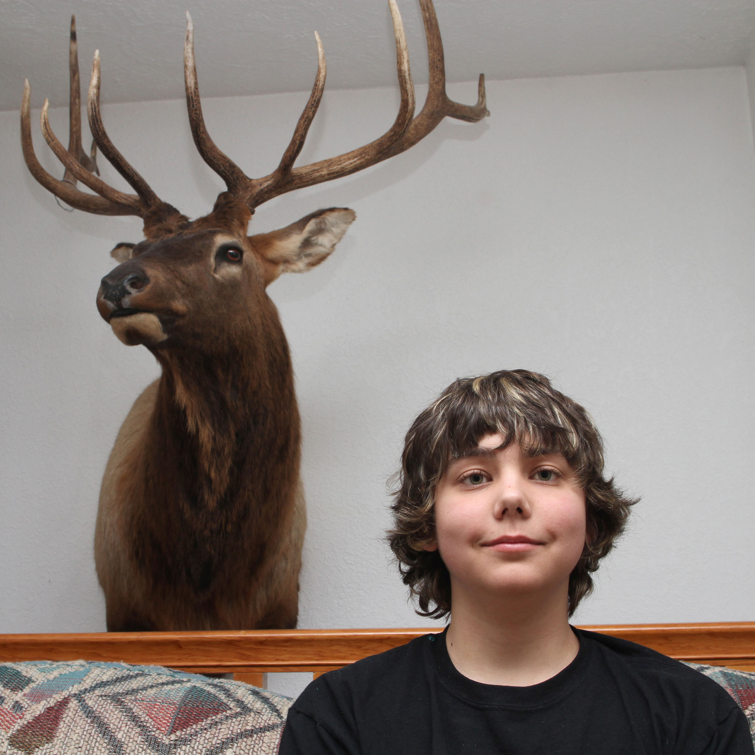  Dillyn Mumme, 15, poses by his 10-point buck in his home in Mount Pleasant. 