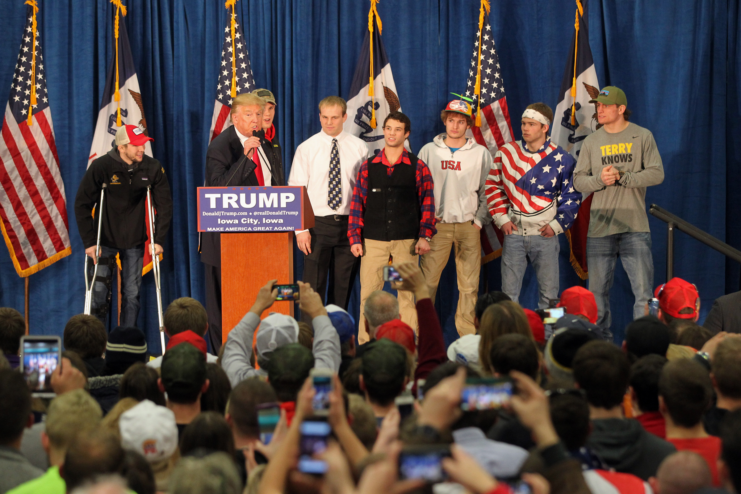 Republican presidential candidate Donald Trump greets members of Iowa's wrestling team at the UI Field House.