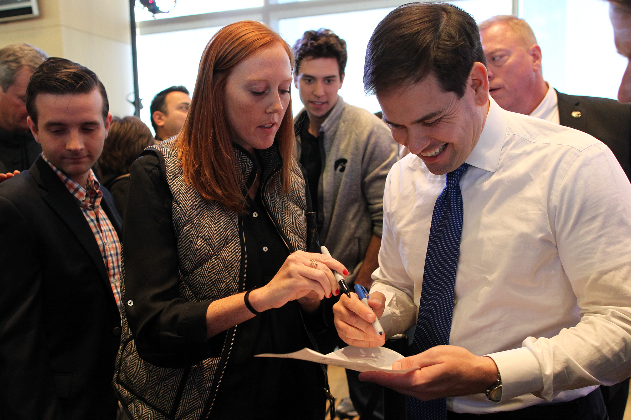 UI graduate student Josie Rudolphi asks Republican presidential candidate Marco Rubio to sign a permission slip to get her out of class following his speech at Kinnick Stadium.