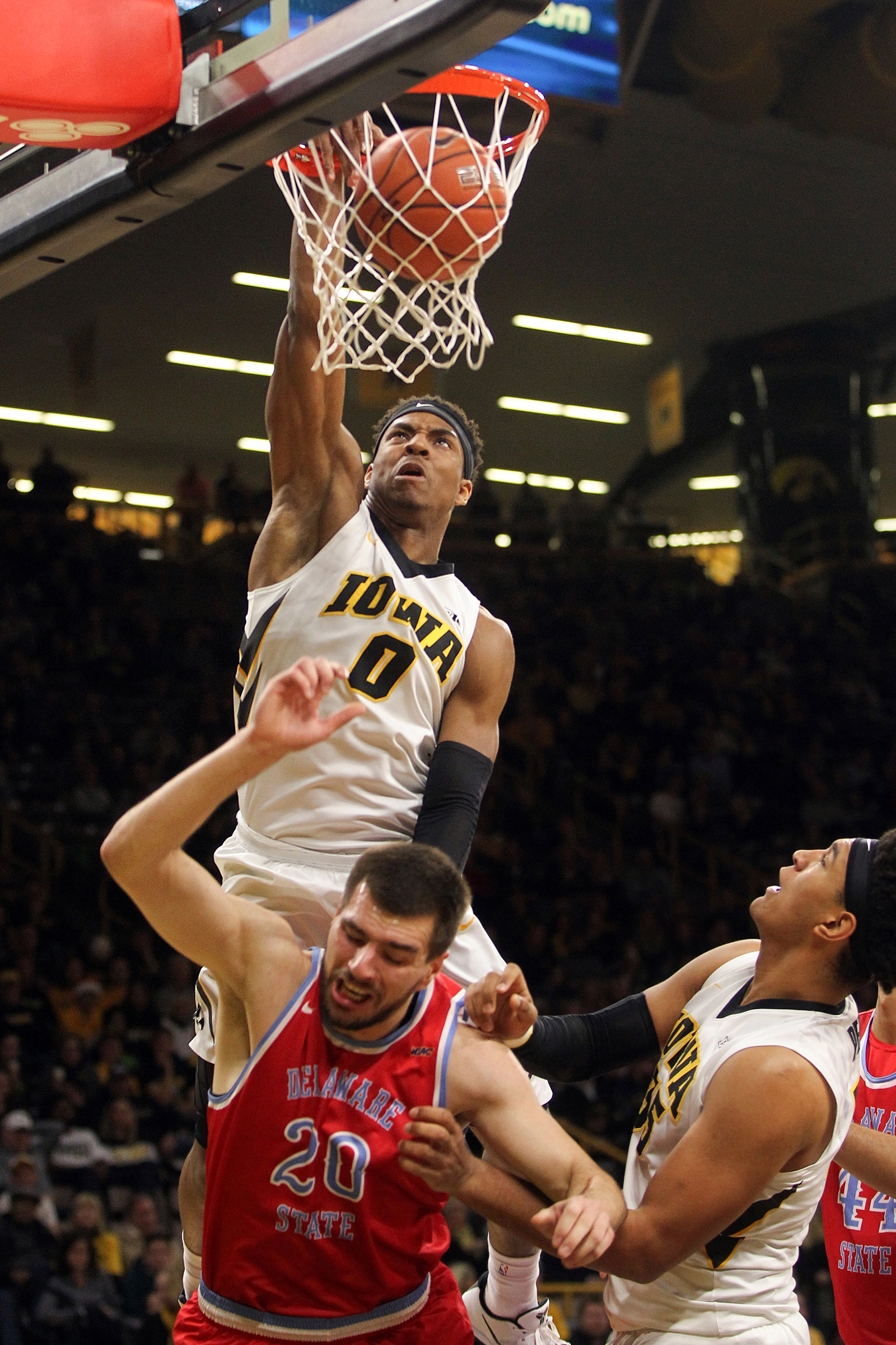  Iowa's Ahmad Wagner dunks the ball, but gets called for a foul, during the Hawkeyes' game against Delaware State at Carver-Hawkeye Arena. 