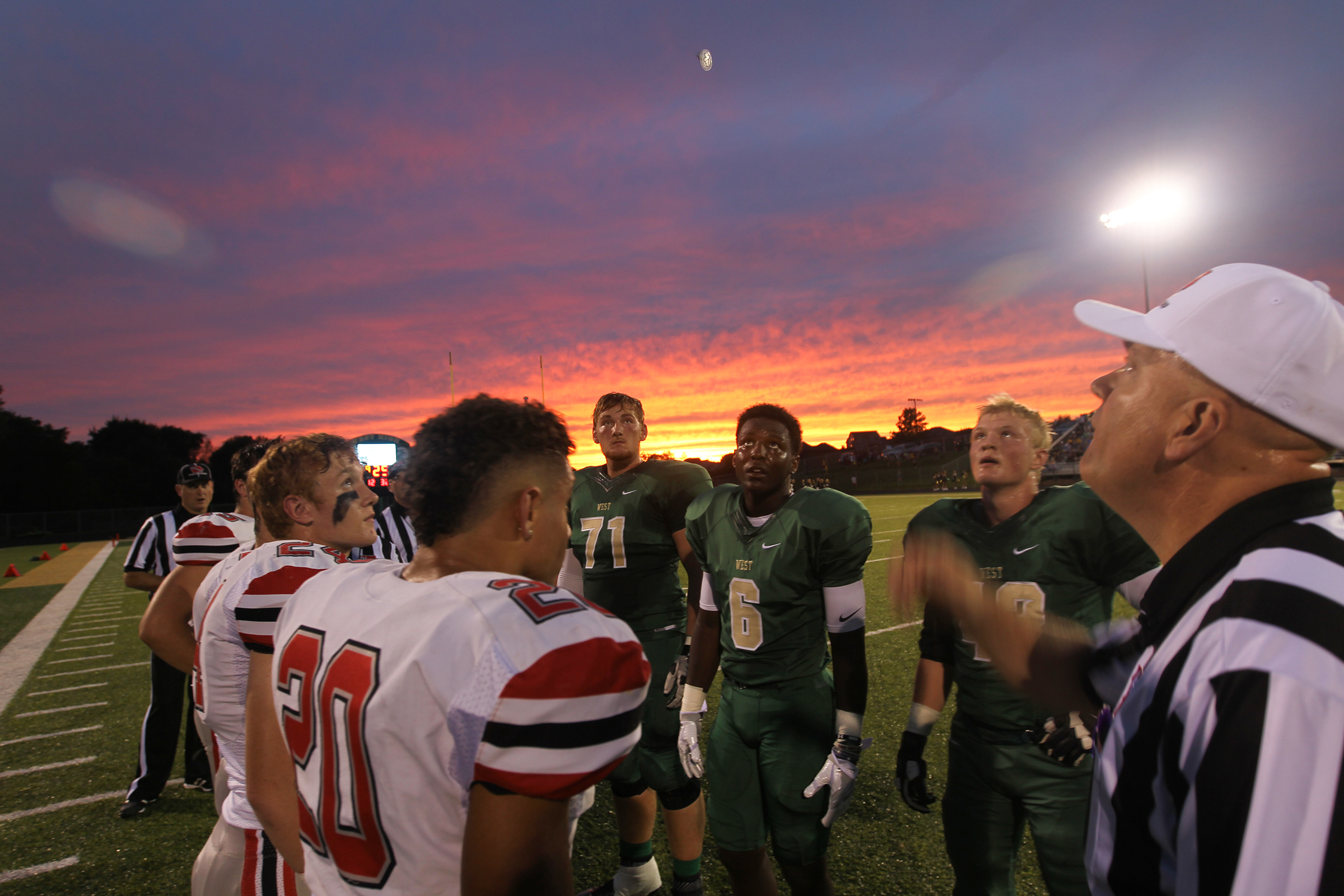  City High and West High players line up for the coin toss before their game at West High. 