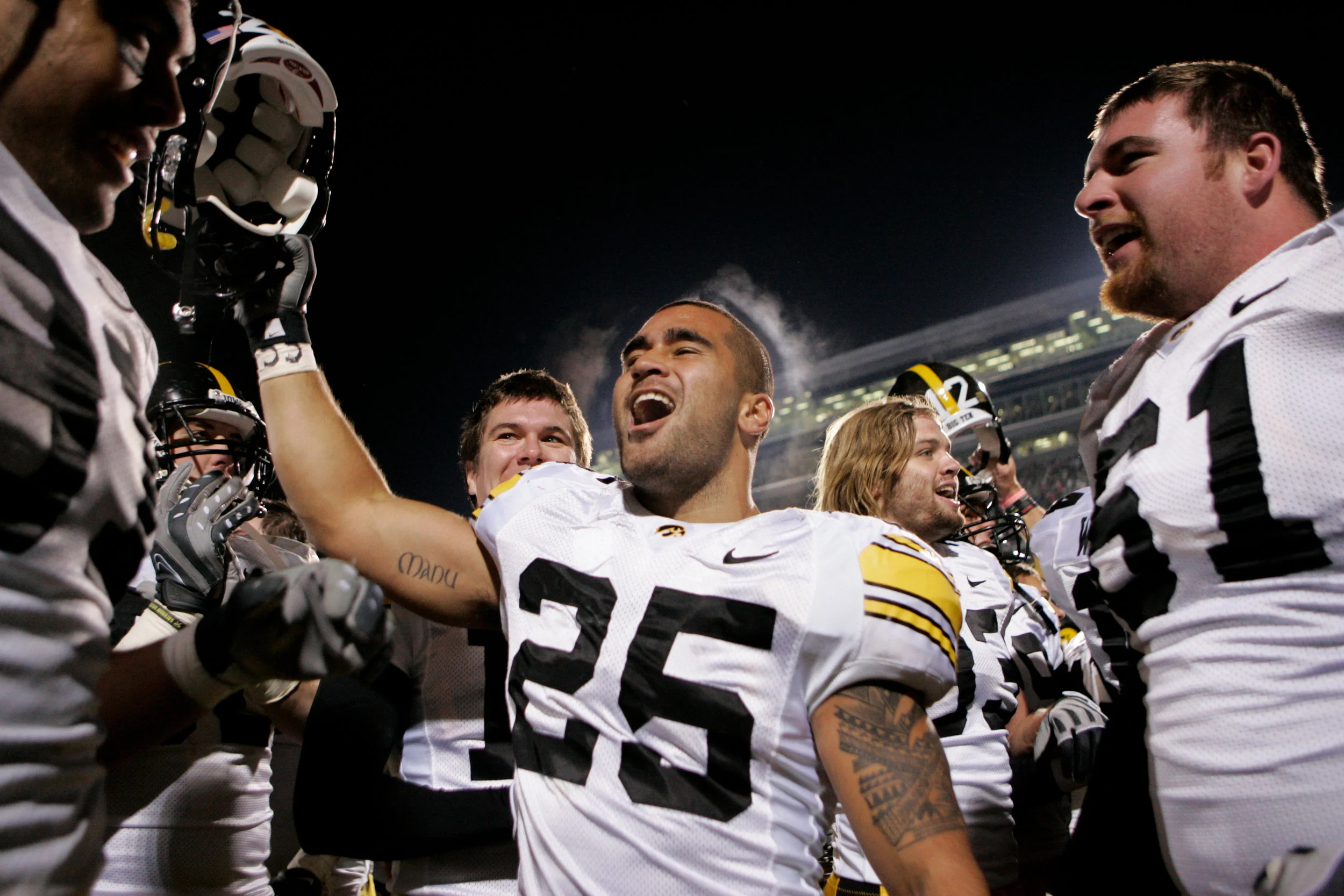 Iowa's Paki O'Meara celebrates with teammates after the Hawkeyes' 15-13 win over Michigan State at Spartan Stadium in East Lansing.