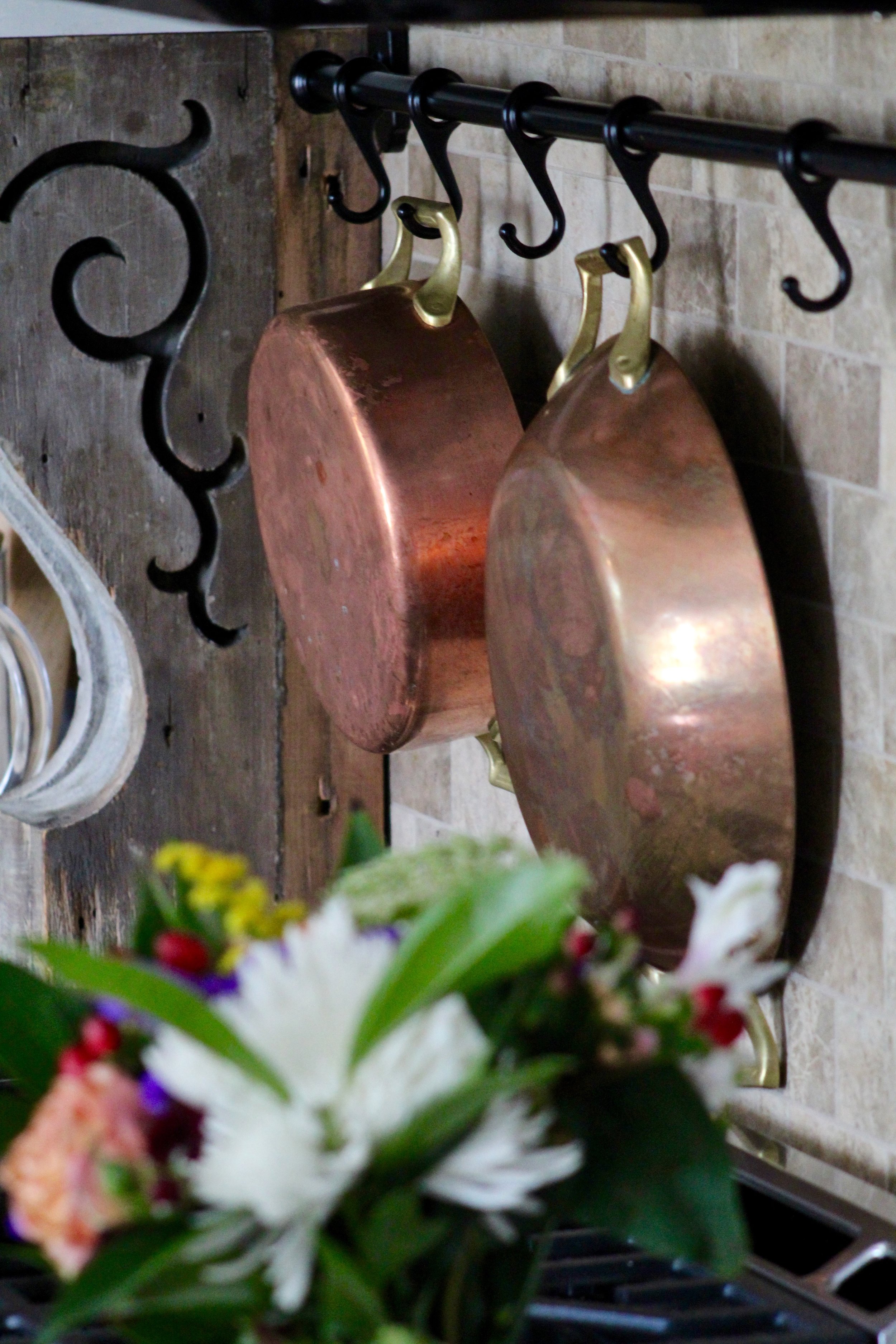 A full set of stunning Paul Revere Copper Pots was given to us by a family friend. To say we are honored she thought enough of us to pass down such an amazing family heirloom is an understatement. They are so loved and will ALWAY hang proudly in my kitchen. Copper is "trending" right now, but I have plans to show these off for the rest of forever! 
