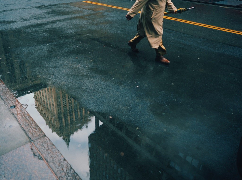 Man walking near puddle midtown New York City by Eric Van Nynatten.JPG