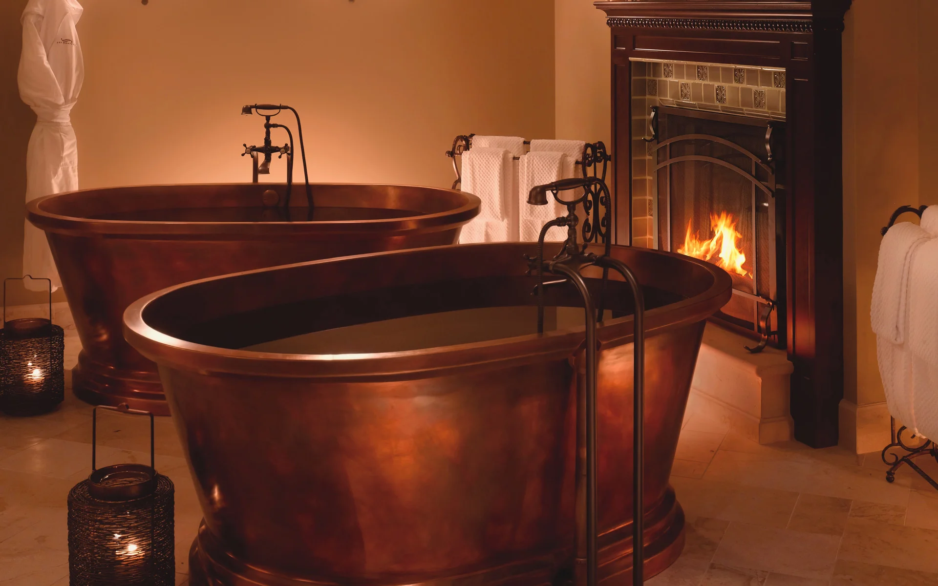 Mr. Luxury Ski prefers to have his apres-ski soak by a crackling fire.