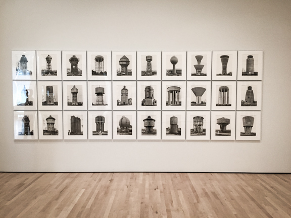 Bernd and Hilla Becher Photographs framed in grey metal frames.