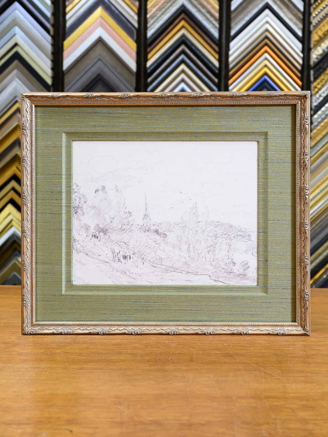 Charcoal sketch framed with fabric matting and an ornate antique-style frame using museum-quality custom framing in San Francisco.