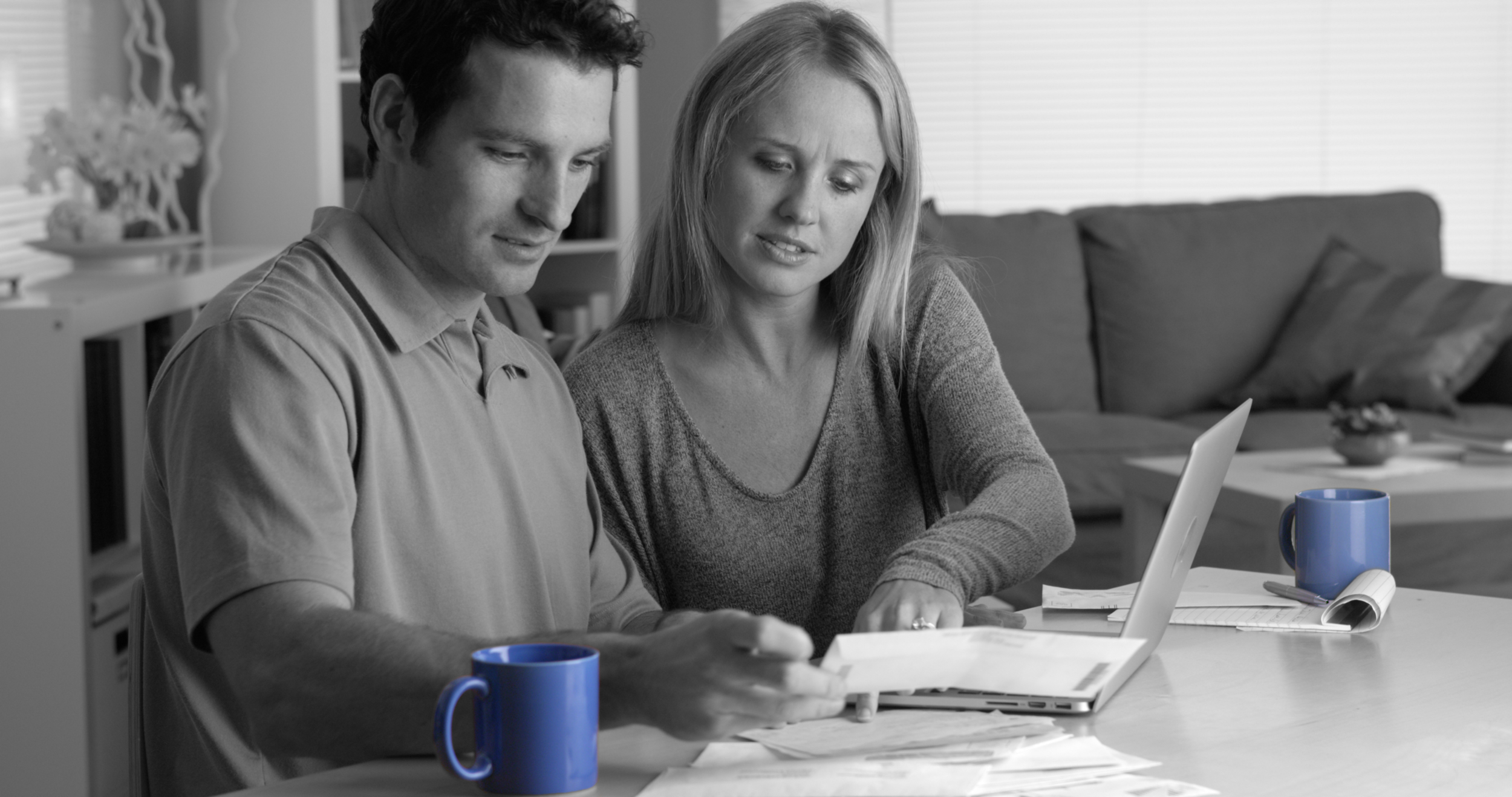 Couple Paying Bills Blue Cups.png