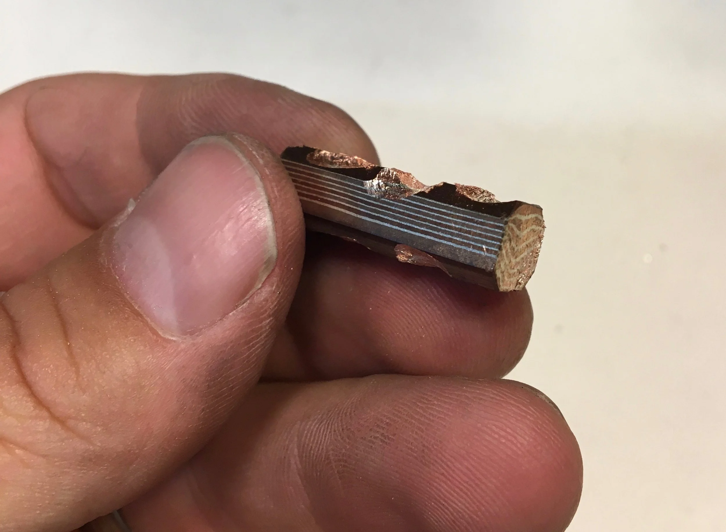 The mokume billet is roughly worked to expose patterns in the different layers of the stock material.