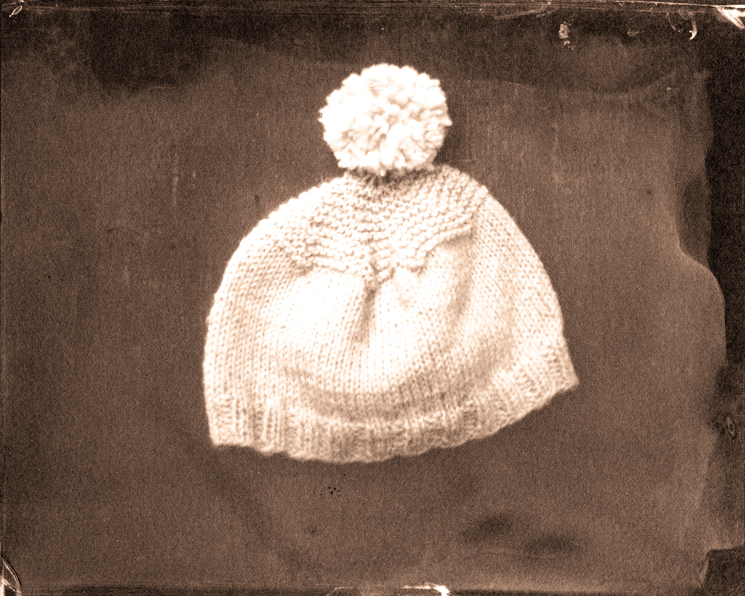 The birth cap she knitted for him.