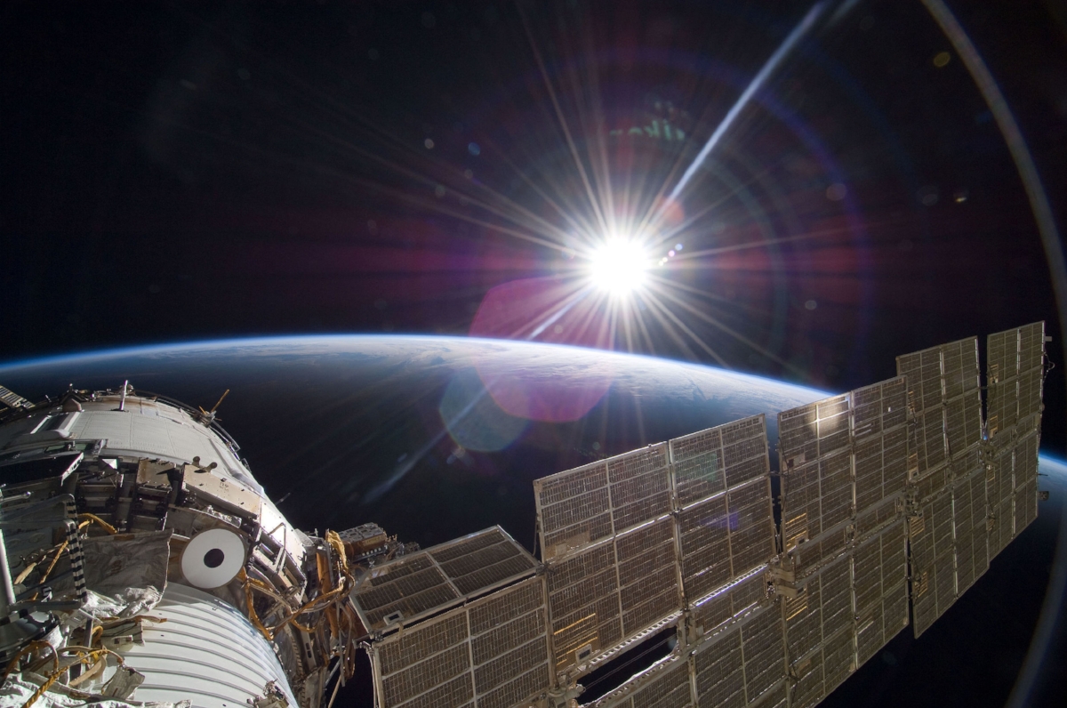"The bright sun greets the International Space Station in this Nov. 22, 2009 scene from the Russian section of the orbital outpost, photographed by one of the STS-129 crew members." 