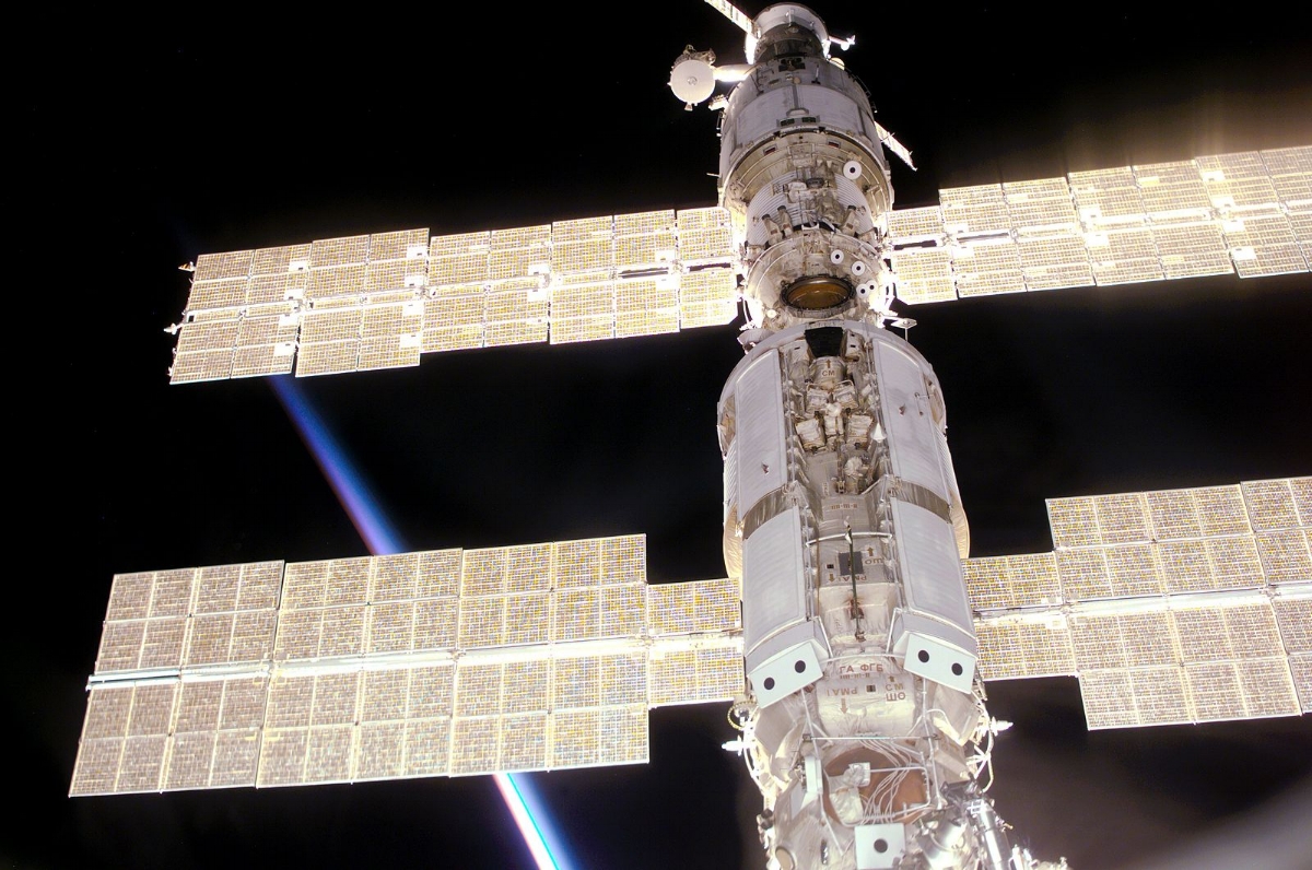 "This view of the International Space Station (ISS) was taken while it was docked with the Space Shuttle Atlantis and shows parts of all but one of the current components. From the top are the Progress supply vehicle, the Zvezda service module, and the Zarya functional cargo block (FGB). The Unity, now linked to the docking system of the Atlantis in the cargo bay, is out of view at bottom. A multicolored layer signals a sunset, in accordance with the stations normal direction of travel and normal orientation, this is also confirmed by the surrounding sequence of images."
