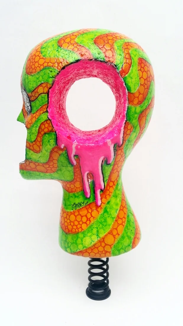 Acrylic Paint and ink on foam head with metal spring