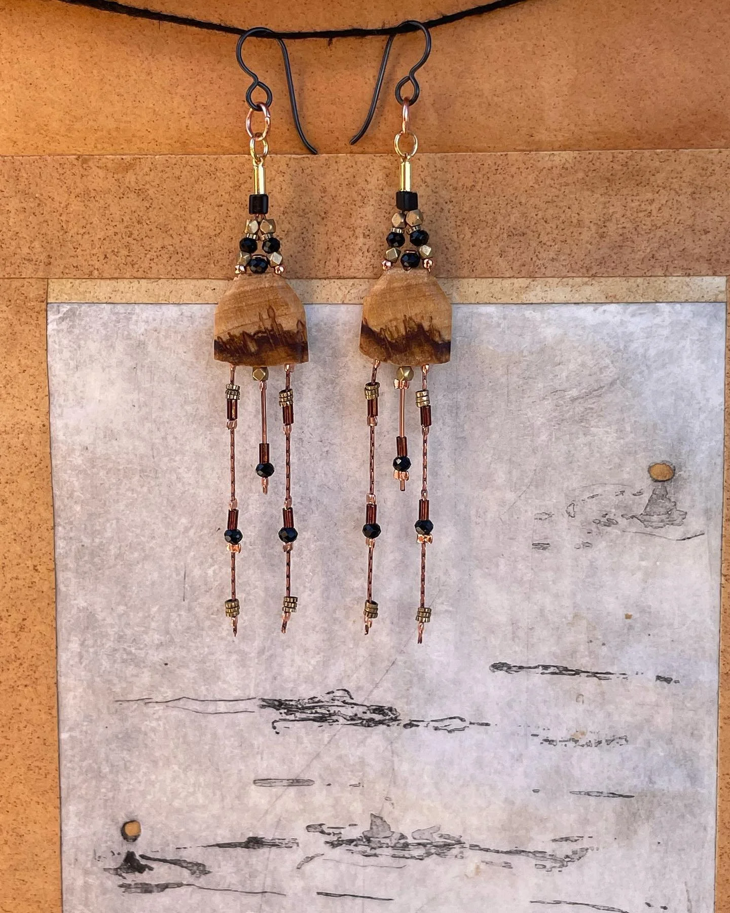 ✨⚫️🕋⚫️✨
Palo Santo Wood Earrings
with Black Tourmaline, Brass Beads,
&amp; Glass Seed Beads
&bull;
Pictured here against an intaglio print scroll made with hand dyed paper. A close up of some golden water droplets can be seen here. 
I also made a cu
