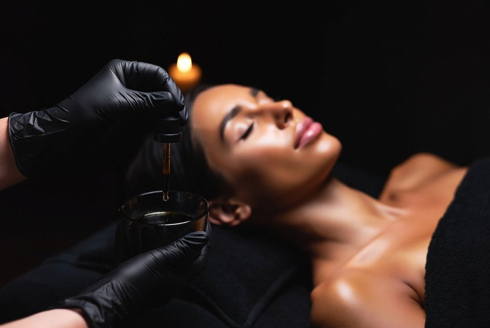 Skin therapist applying a layered glycolic peel in San Diego