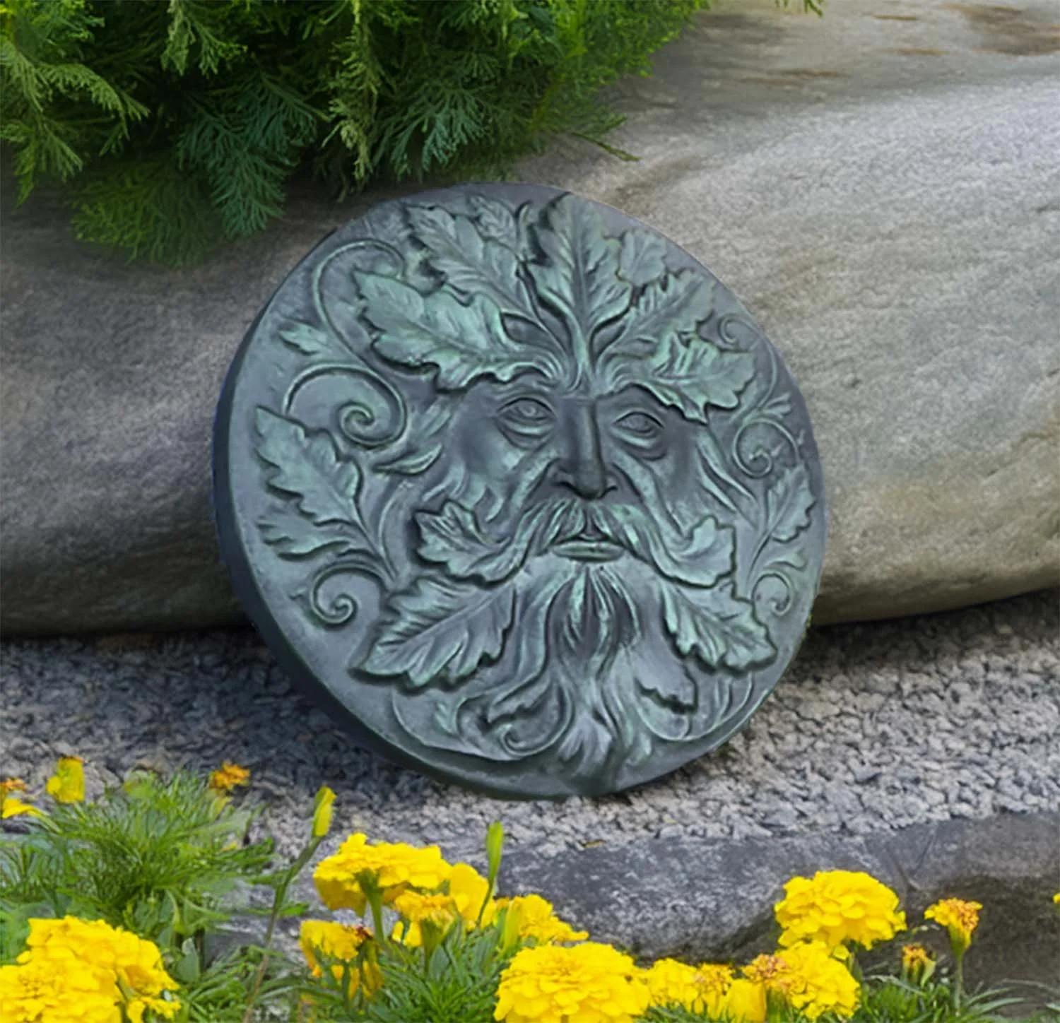 Green Man stepping stone setting in a flower garden